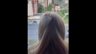 I fuck a girl while she stands on the balcony and looks out the window