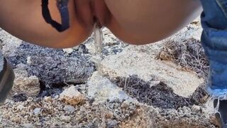 Teen peeing outside on a mountain